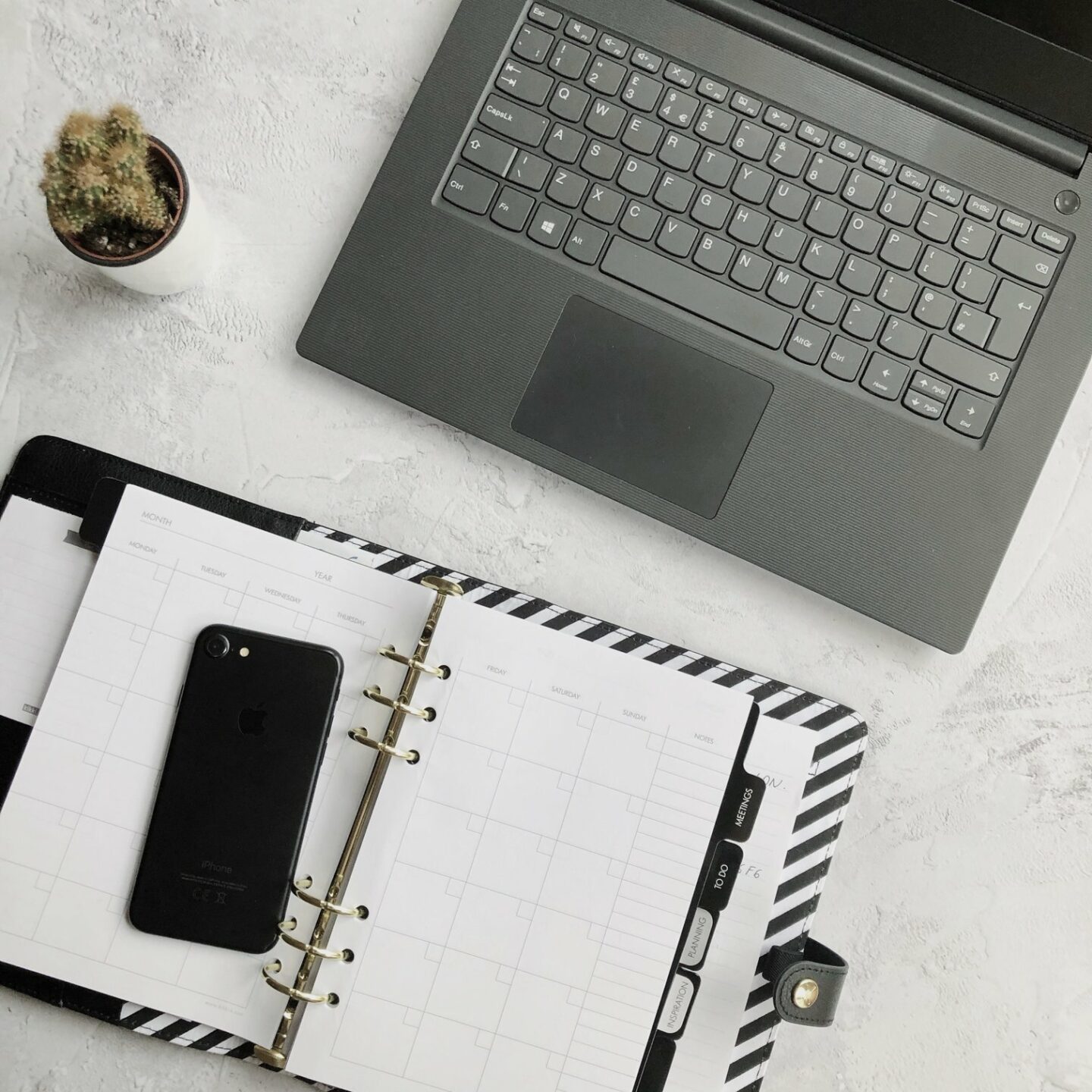 Home office: laptop and notebooks on grey background