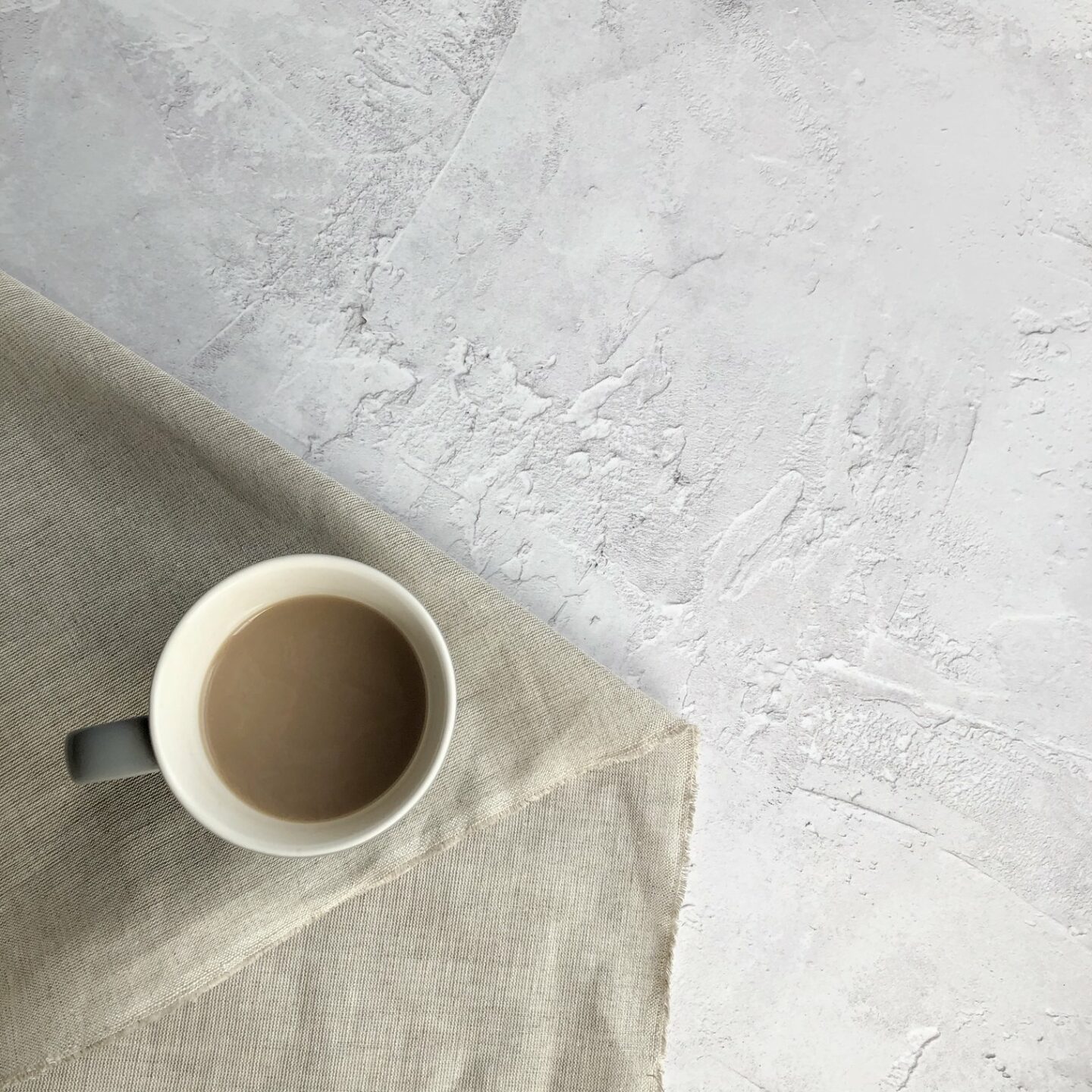 Cup of tea on fabric on a grey background