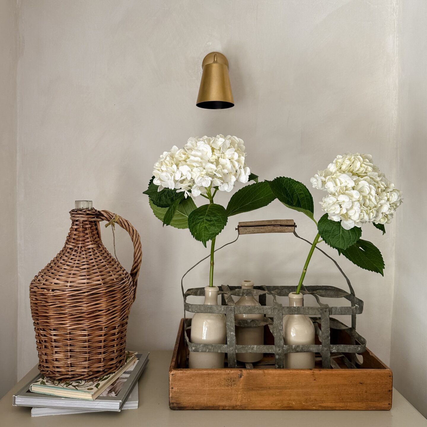 White hydrangeas in vintage bottle carrier