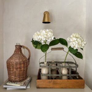 White hydrangeas in vintage bottle carrier